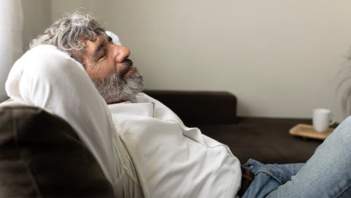 man resting on couch