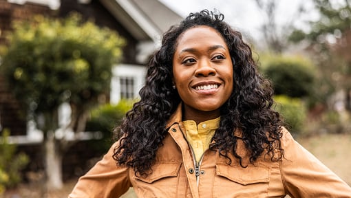 woman smiling outside being mindful