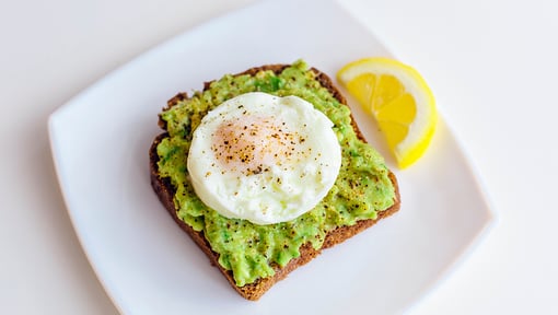 egg and avocado toast on a plate for a after workout snack