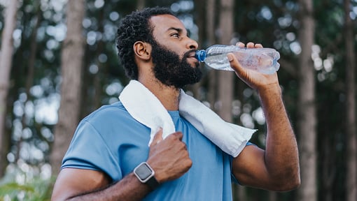 a man hydrating with water before a workout