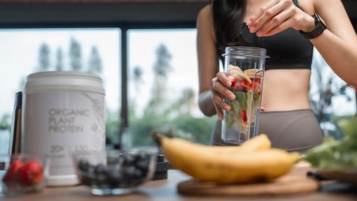 woman making a post workout smoothie