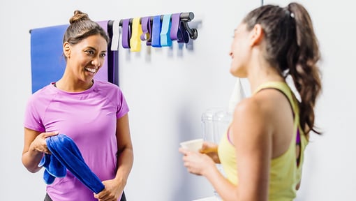 two women chatting at the gym