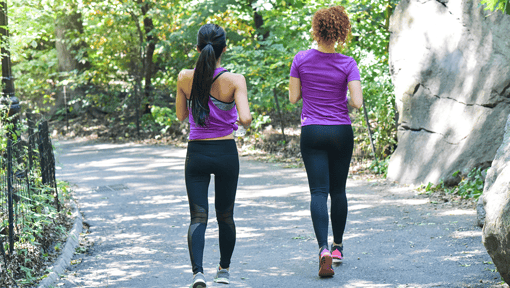 Two women outside doing a mini walking workout
