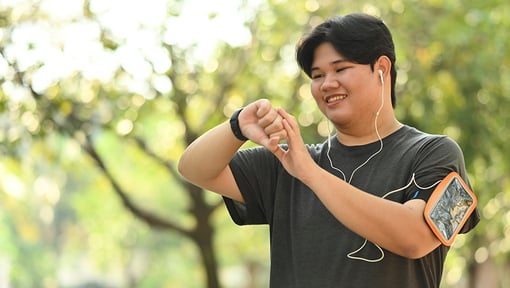 Young adult checking health stats on smart watch