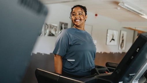 Woman walking on a treadmill while doing a low intensity steady state cardio exercise