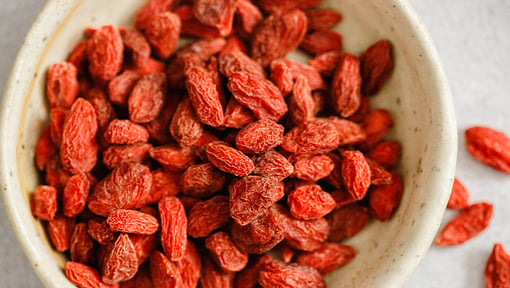 A close up of a bowl filled with superfood drided goji berries