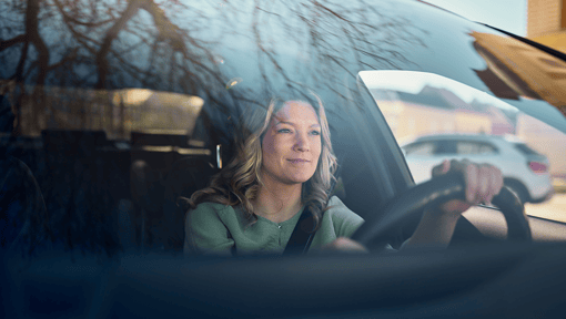 A woman taking a micro-moment of mindfulness while driving.