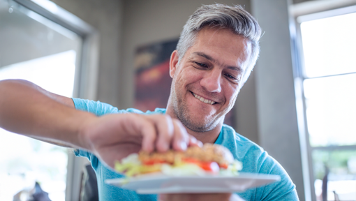 A man choosing a nutritious sandwich as part of a healthy eating and balanced lifestyle routine.